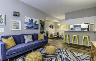 a living room with a blue couch and pillows