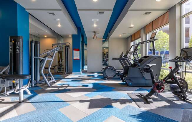 a gym with cardio machines and weights at the flats