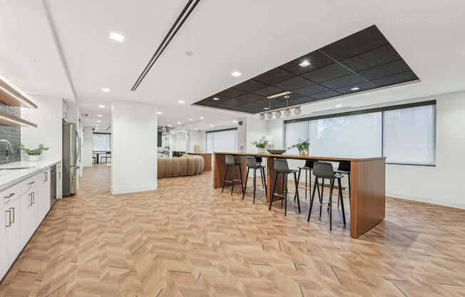A modern kitchen with a dining table and chairs.