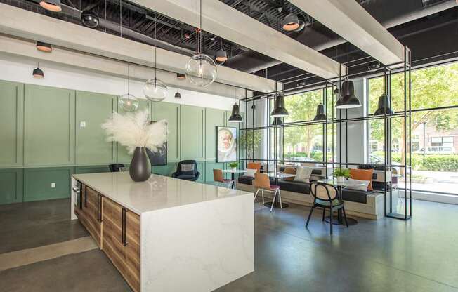 a large room with a kitchen island and a living room with couches