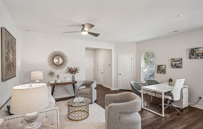 a living room with a dining room table and chairs and a ceiling fan