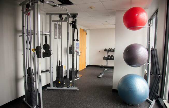 a fitness room with exercise equipment and a ball