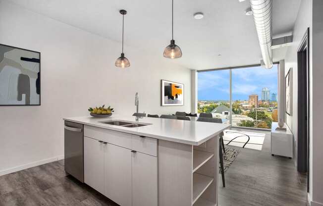an open kitchen with an island and a view of the city