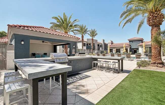 a patio with tables and chairs and palm trees