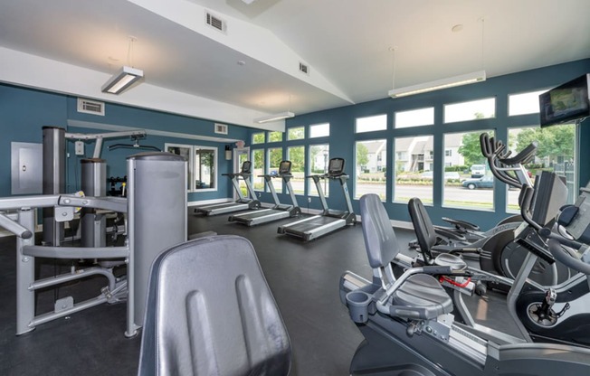 a gym with cardio equipment and windows at Misty Ridge Apartments, Woodbridge, 22191