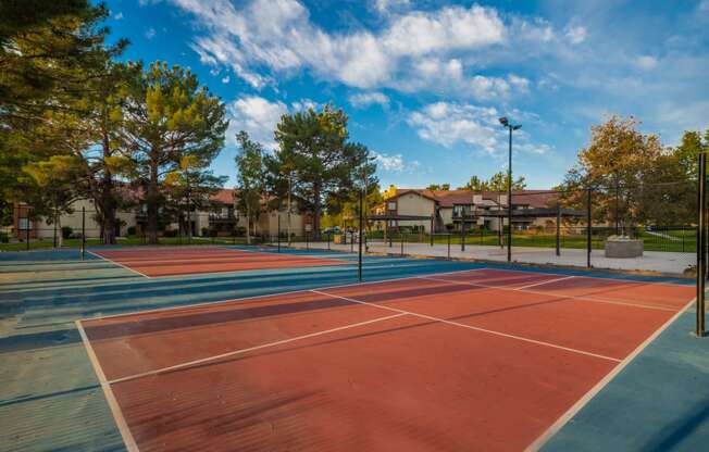 two tennis courts at the whispering winds apartments in pearland, tx