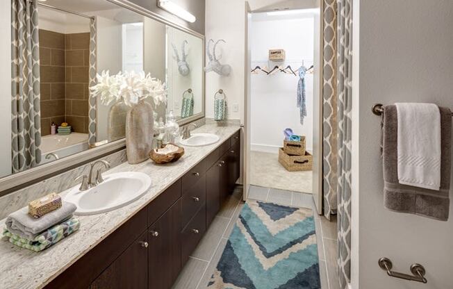 a bathroom with two sinks and a shower