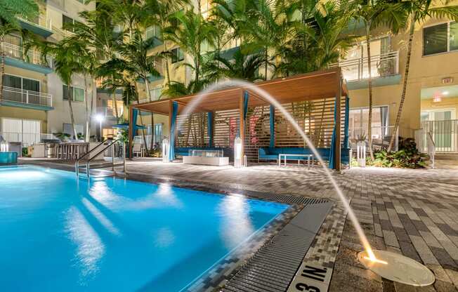 a large swimming pool with a water fountain