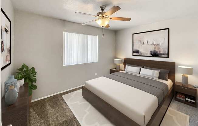 A bedroom with a large bed and a ceiling fan.