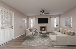 A living room with a fireplace and a television.