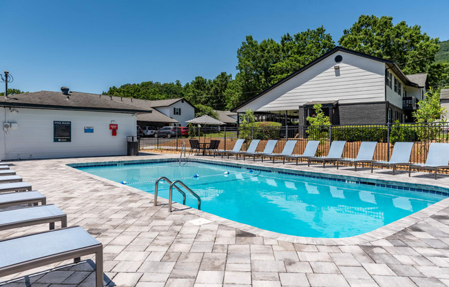 our resort style swimming pool is in front of our house with lounge chairs