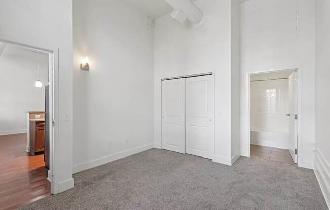A large room with white walls and a carpeted floor.