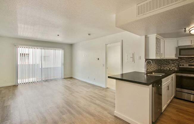 a kitchen and living room with a large window  at Masselin Park West, Los Angeles, CA