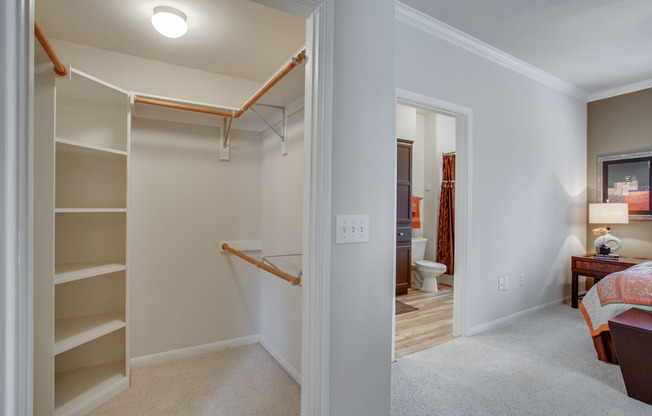 View of Bedroom with Closet, Bed, and View of Bathroom at Raveneaux Apartments