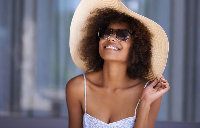 a person wearing a hat and sunglasses