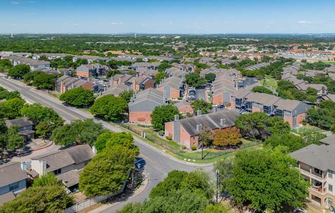 an aerial view of a neighborhood with houses and trees