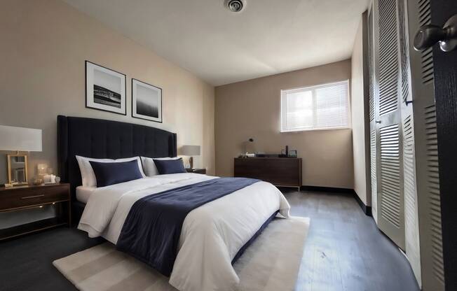 a bedroom with a bed and a dresser and a window
