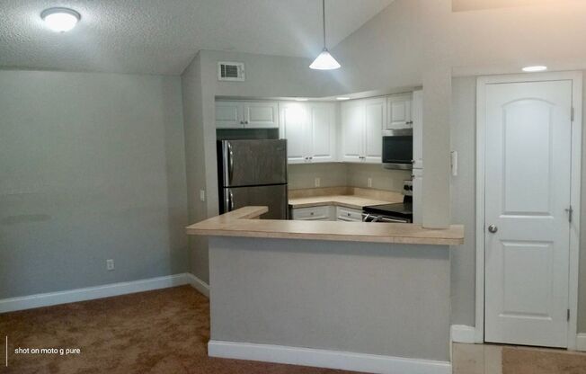 Spacious third floor unit located in the gated community of Venetian place