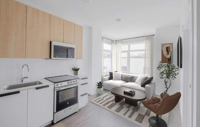A modern kitchen with white cabinets and a black countertop.