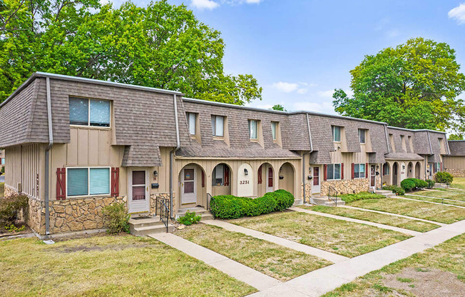 a row of houses with trees in the background