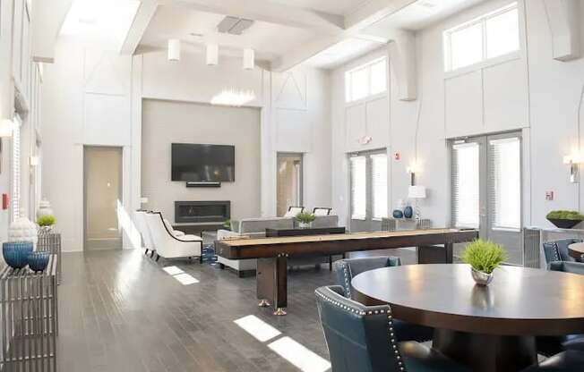 A modern living room with a dark wood floor and white walls.