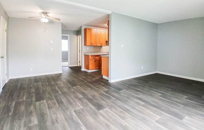 A room with wooden flooring and a ceiling fan.