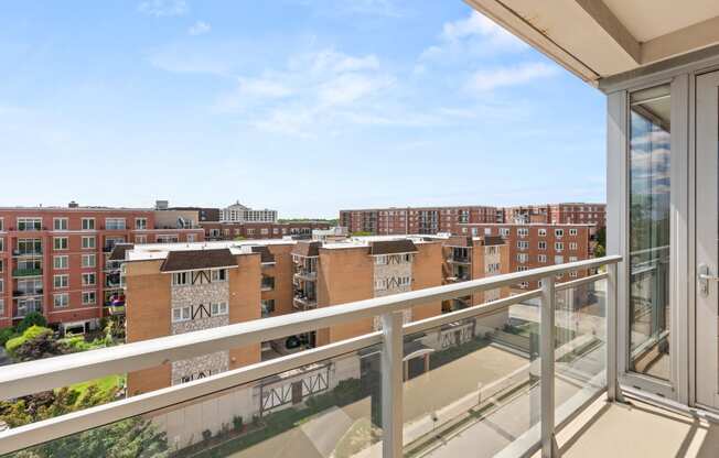 the view of the city from the balcony of an apartment building