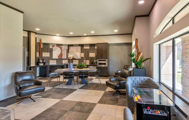 A modern living room with a black leather chair and a grey sofa.
