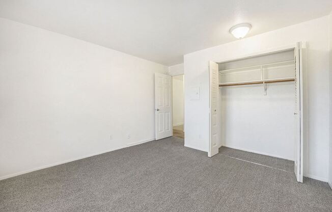 bedroom with a closet and plush carpeting at Hampton Lakes Apartments, Michigan, 49534