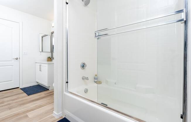 a bathroom with a shower and a sink