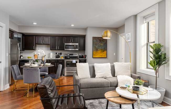 a living room and kitchen with a couch and a table