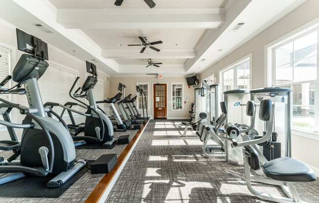 Premium fitness center with cardio equipment and weight machines at Riverstone apartments for rent in Macon, GA