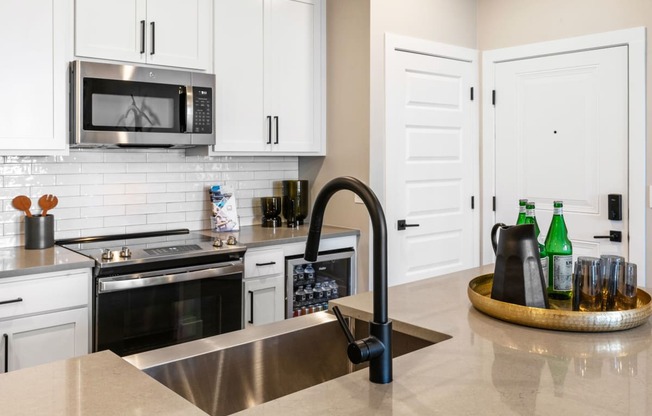 a kitchen with stainless steel appliances and white cabinets