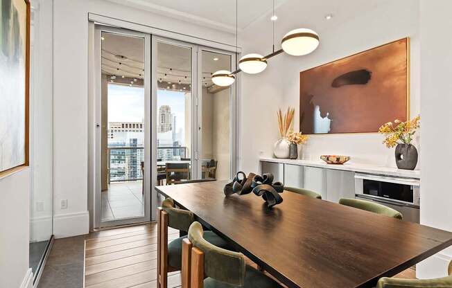 A modern dining room with a wooden table and chairs.