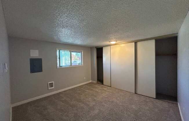 A room with a window and a door.