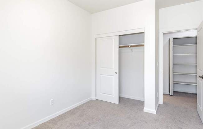 A white door is open in a room with a carpeted floor at The Landing Apartments and Townhomes, Oregon, 97045