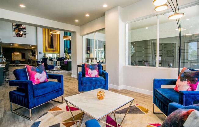 a living room with blue chairs and a white coffee table