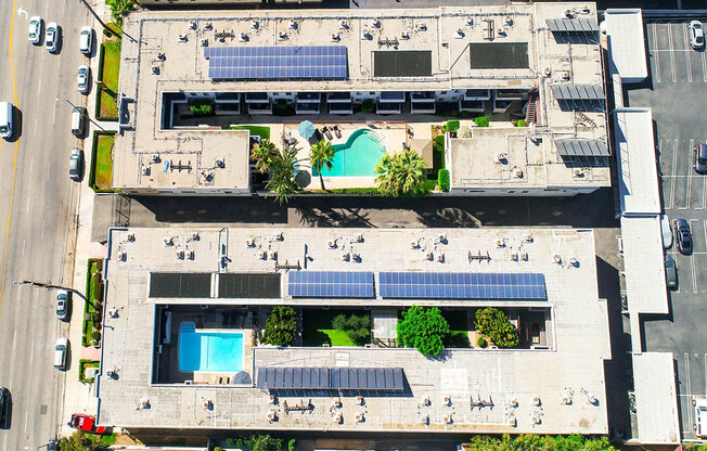 Aerial drone image of Sherman Oaks Gardens, showing solar panels and energy-efficient white roof.