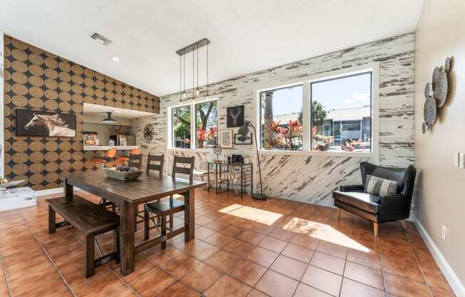 a dining room with a wooden table and chairs and a large window