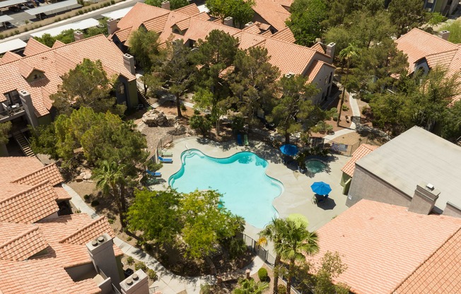 an aerial view of a swimming pool surrounded by houses