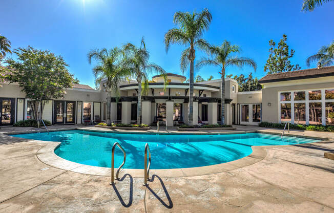 a mansion with a swimming pool and palm trees