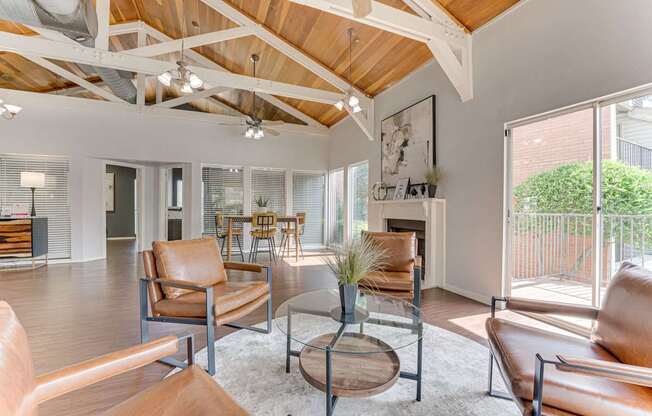 A living room with brown leather chairs and a wooden coffee table at Copper Hill Apartments, Bedford, TX, 76021