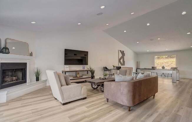 A modern living room with a fireplace and a large couch.