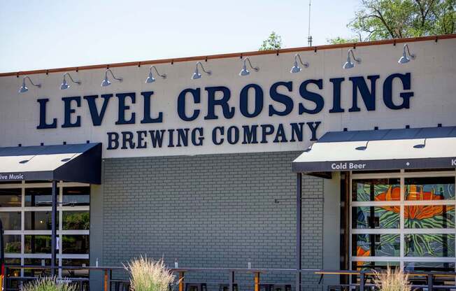 A beer company called Level Crossing has a building with a sign on it.