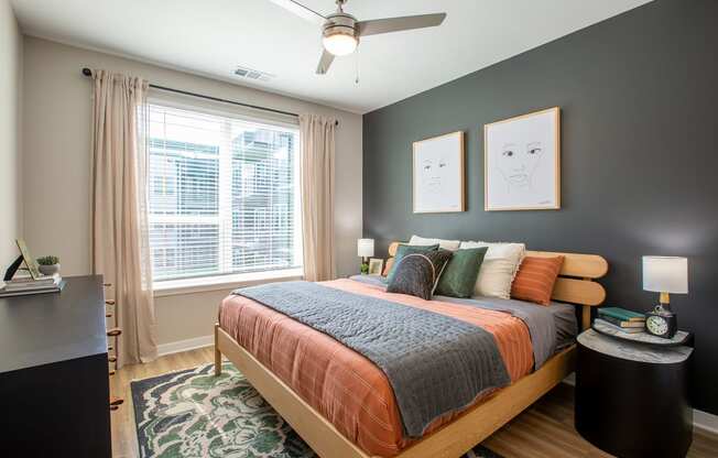 a bedroom with a bed and a ceiling fan