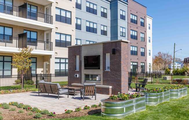 A modern building with a brick fireplace in the courtyard.