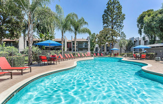 swimming pool with red chairs and umbrellas at the resort at governors crossing