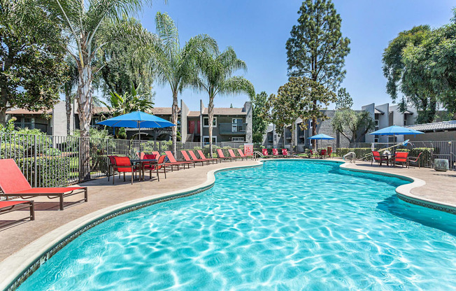 swimming pool with red chairs and umbrellas at the resort at governors crossing