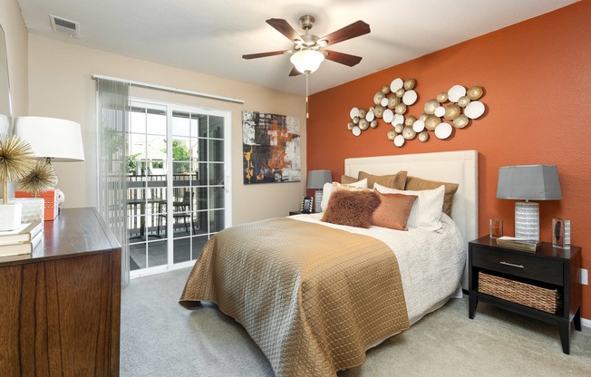 a bedroom with a bed and a ceiling fan