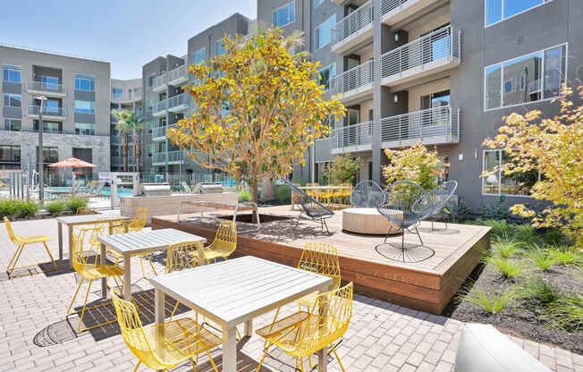 an outdoor patio with tables and chairs